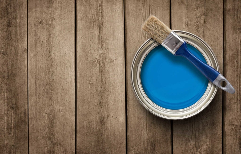 Paint can on the old wooden background